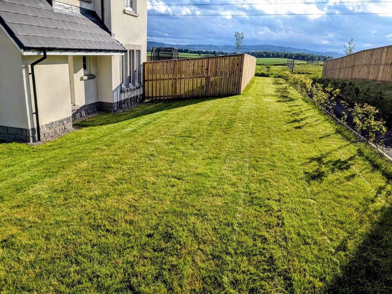 Striped grass cutting across a large lawn by SA Lawn and Grounds in Aberdeenshire